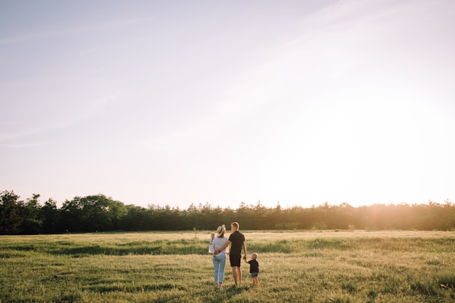 Family standing in a open field